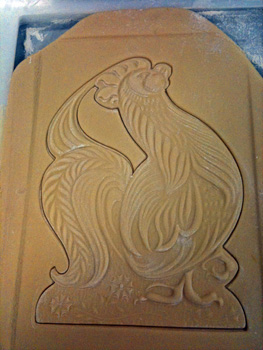 rooster-shaped cookie cut out with wood cookie mold
